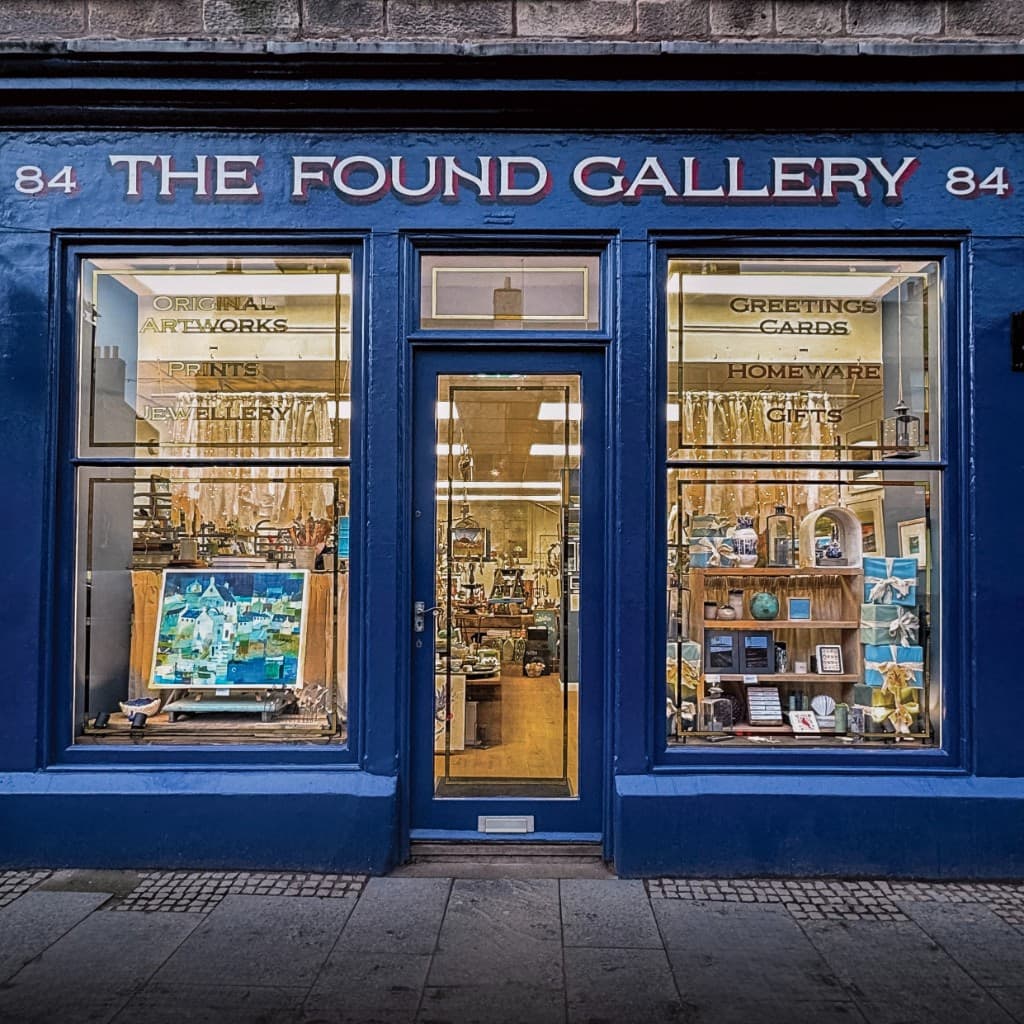 The deep blue shopfront of The Found Gallery at 84 High Street, Dunbar, with display windows of artworks, ceramics and gifts.
