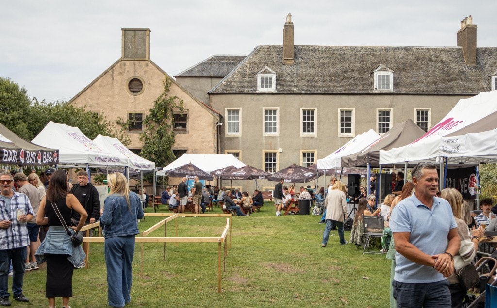A wide view of Cockenzie House, the gardens and people attending EH32 Live.