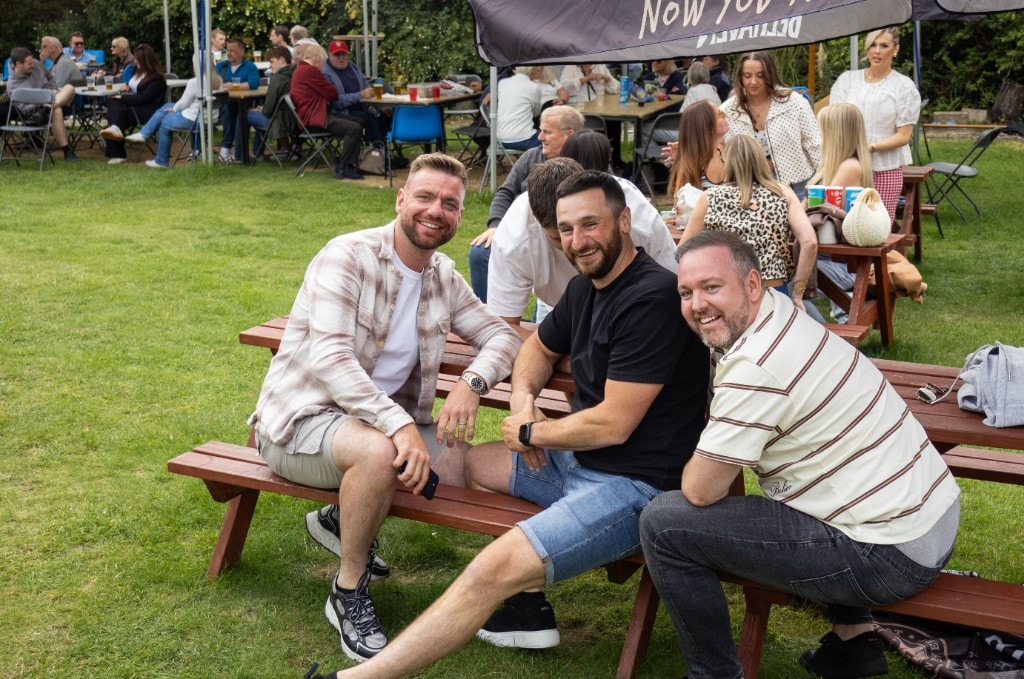 Three men standing together at EH32 Live in the gardens of Cockenzie House.