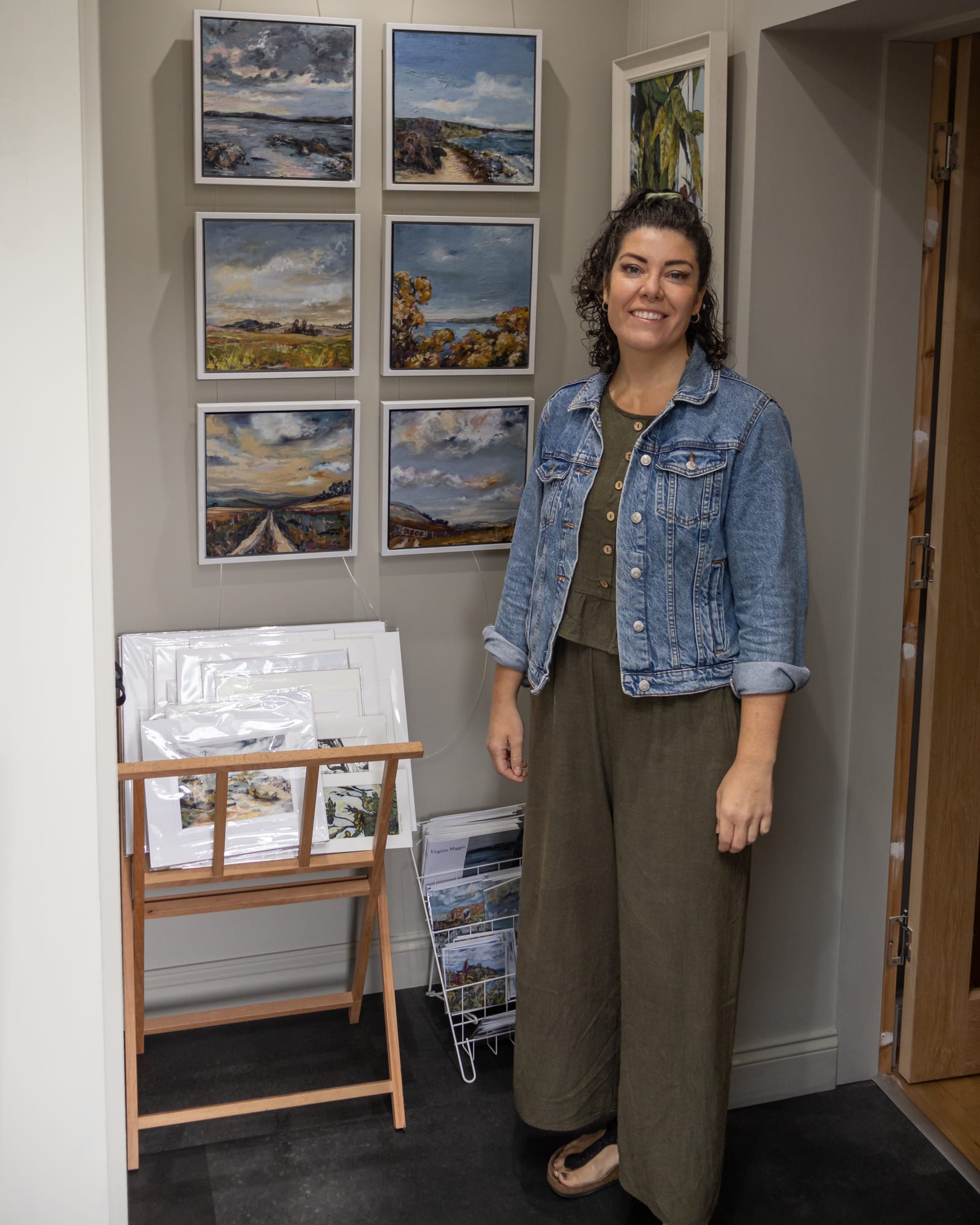 Virginia Maggio beside her East Lothian landscape paintings